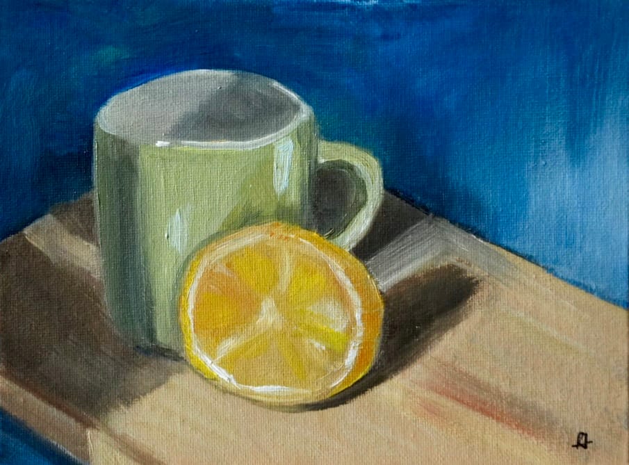 Green cup and lemon